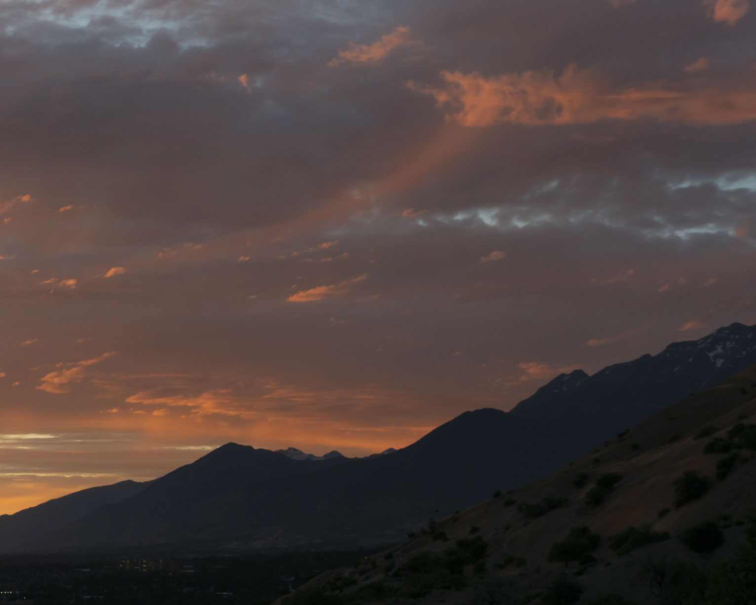 Lit whisps up in the sky following the diagonal of the mountainside